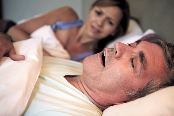 couple-in-bed-sleep-apnea-Snoring