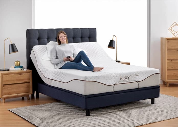 woman sitting on an adjustable bed