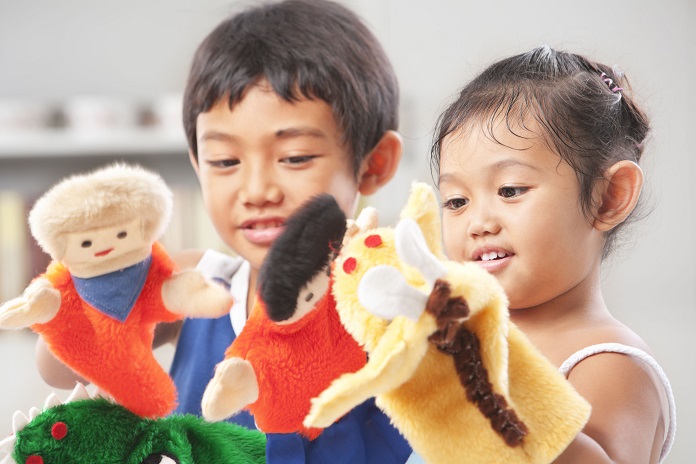 kids playing with  puppets