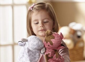 girl playing with puppets