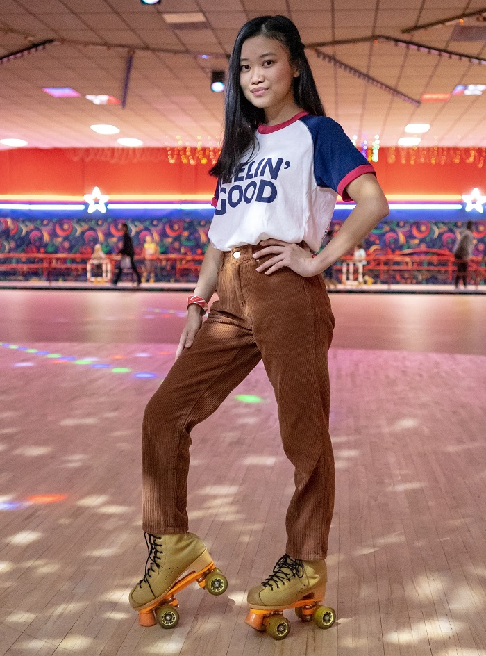picture of a girl in a hall riding roller skates