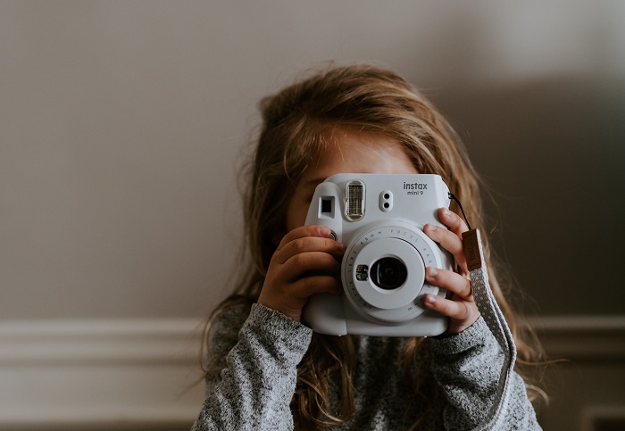 picture of a girl with an instant camera