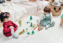 picture of kids sitting on the ground and playing with toys