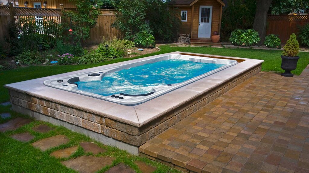 Swim, play or relax, swim spas offer the perfect alternative to a pool. Essentially, a swim spa gives you all the functionality of a swimming pool, with added features usually found on a spa. Most spas are portable, self-contained above-ground units made of fibreglass, acrylic with a fibreglass backing, or polyethylene. Swimming in a spa feels like you are swimming in open water due to the natural turbulence. Of course, it all depends on the model and jet style. Different models offer different features. Most swim spas feature strong hydrotherapy jets as well as temperature control while some offer them as upgrades. In addition, you can optimize your spa pool with the optional underwater treadmill that will take your fitness to new levels.