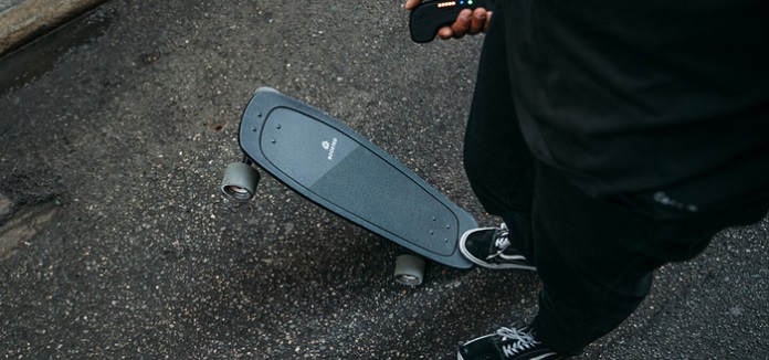 person stepping on a boosted mini X electric skateboard 