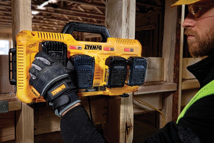 Close-up of worker attaching dewalt battery to charge