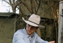 man wearing a cowboy hat on a farm