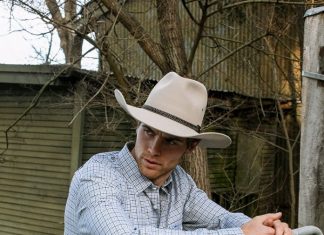 man wearing a cowboy hat on a farm
