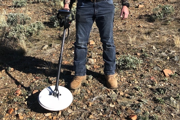Man prospecting gold on rocky terrain with Minelab GPZ 7000